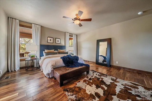 a spacious bathroom with a double vanity sink a large mirror a bathtub and next to a window