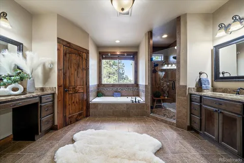 a bathroom with a tub sink and mirror