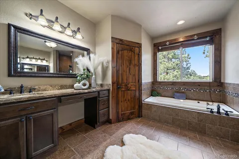 a view of a hallway with wooden floor and stairs
