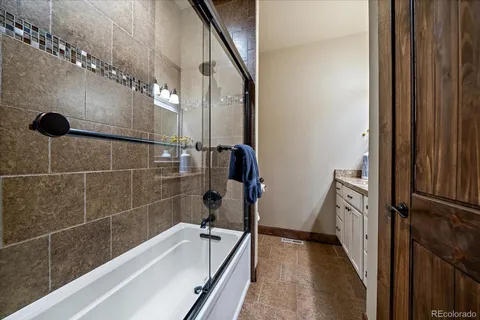 a bedroom with a bed and a potted plant on the dresser
