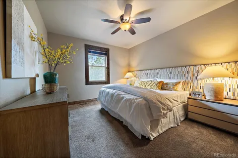 a bathroom with a granite countertop sink and a large mirror