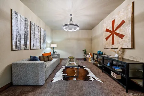 a dining room with wooden floor and a chandelier
