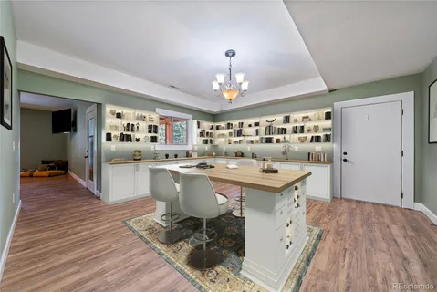 a view of a patio with table and chairs and floor to ceiling window with wooden floor