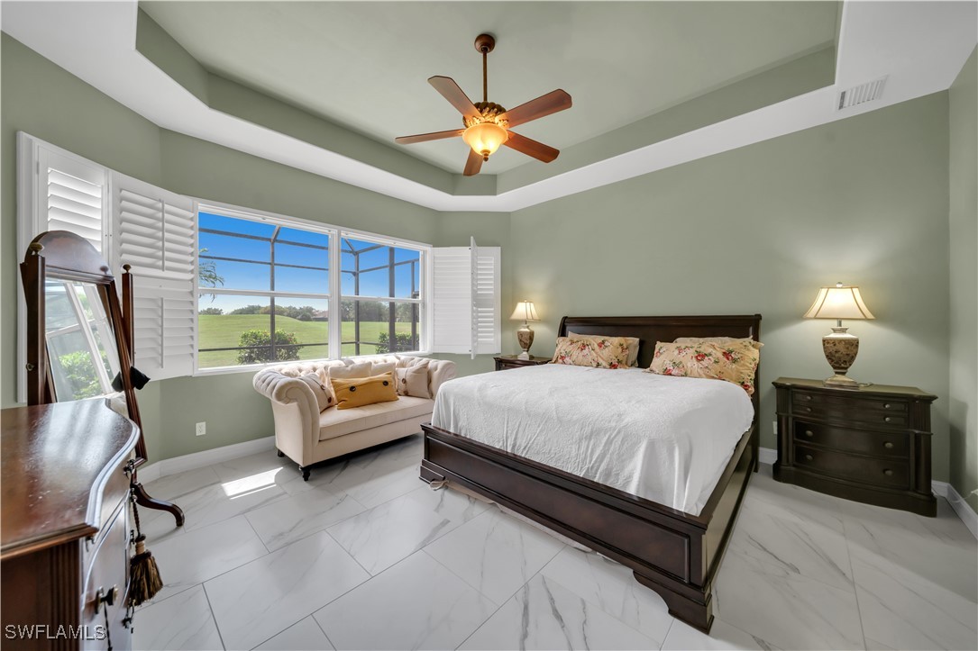 7672 Sussex Court Naples, FL 34113 - Photo 13 of 28 a bedroom with a bed and a large window