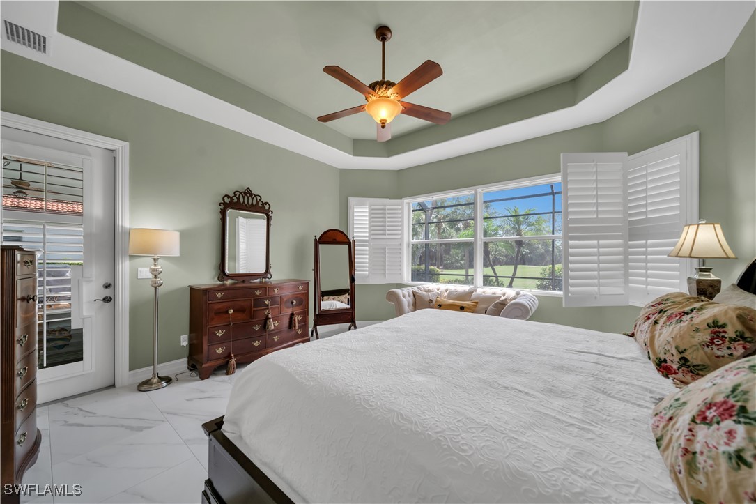 7672 Sussex Court Naples, FL 34113 - Photo 14 of 28 a bedroom with a bed and window
