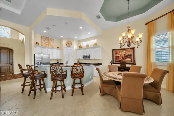 a large kitchen with a table and chairs