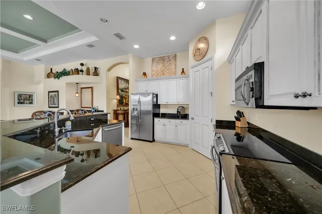 a kitchen with sink stove and cabinets