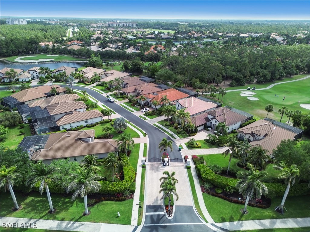 7672 Sussex Court Naples, FL 34113 - Photo 19 of 28 an aerial view of residential houses with outdoor space and trees