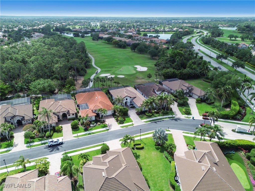 7672 Sussex Court Naples, FL 34113 - Photo 20 of 28 an aerial view of a city with lots of residential buildings