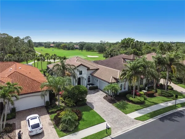 an aerial view of a house with garden space and street view
