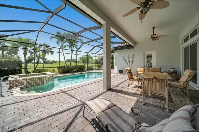 a view of a patio with table and chairs floor to ceiling window with wooden floor