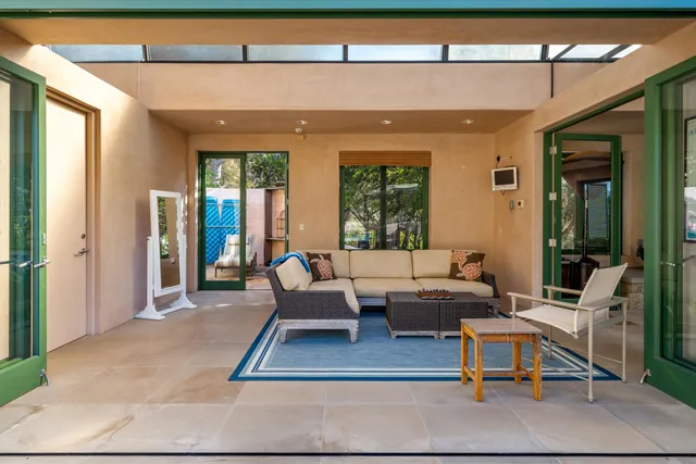 a living room with furniture and a floor to ceiling window