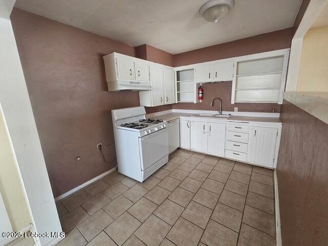 4508 46th Street Lubbock, TX 79414 - Photo 5 of 9 a kitchen with a stove a sink and a refrigerator