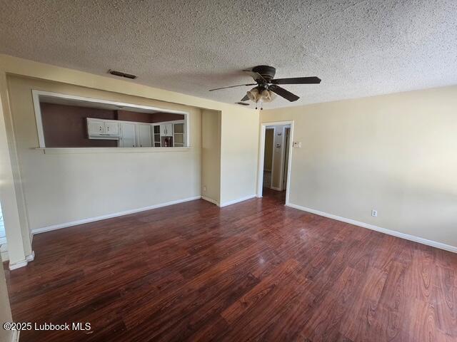 4508 46th Street Lubbock, TX 79414 - Photo 6 of 9 a view of a big room with wooden floor and a ceiling fan
