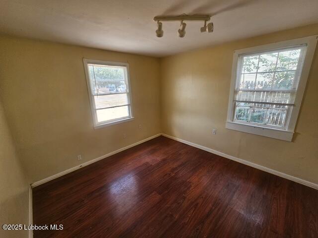 4508 46th Street Lubbock, TX 79414 - Photo 7 of 9 a view of an empty room with wooden floor and a window