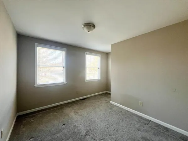 an empty room with a empty space and windows