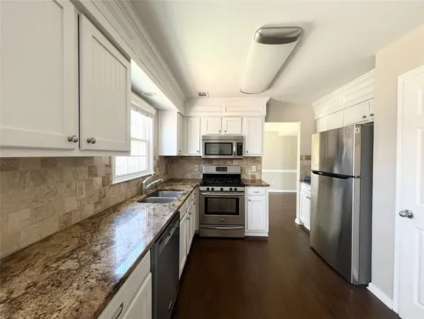 a kitchen with a refrigerator a sink and a stove