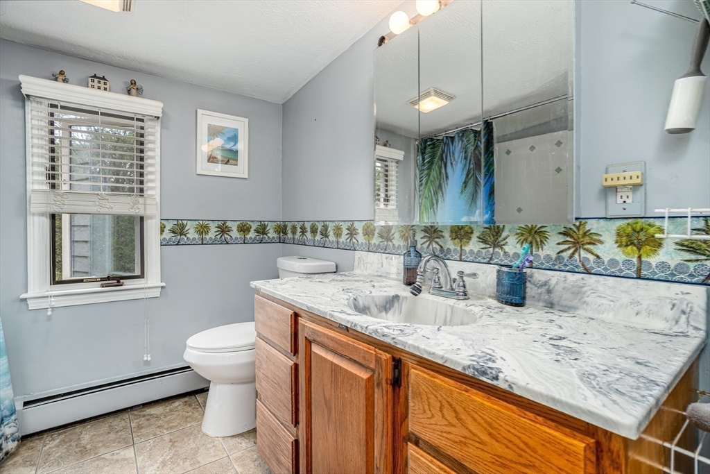 188 Hubbardston Road Templeton, MA 01468 - Photo 16 of 33 a bathroom with a granite countertop double vanity sink a mirror and a toilet