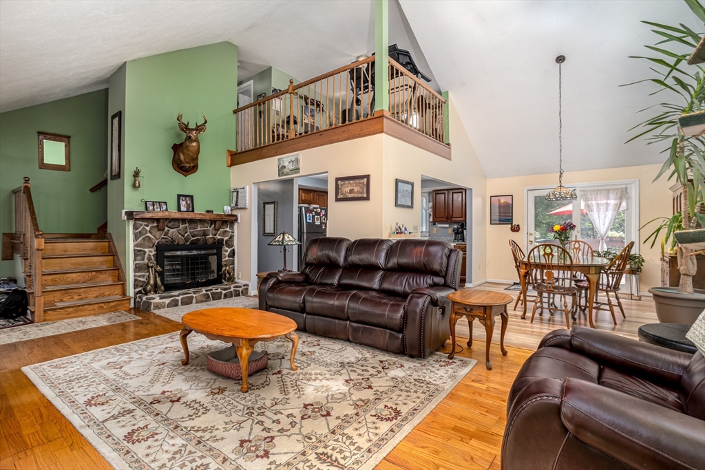 188 Hubbardston Road Templeton, MA 01468 - Photo 6 of 33 a living room with furniture a fireplace and a table