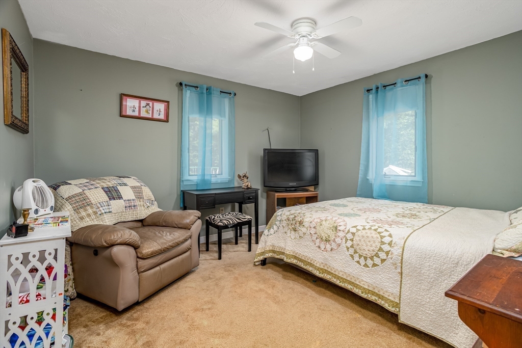 188 Hubbardston Road Templeton, MA 01468 - Photo 8 of 33 a bedroom with a bed and a flat screen tv