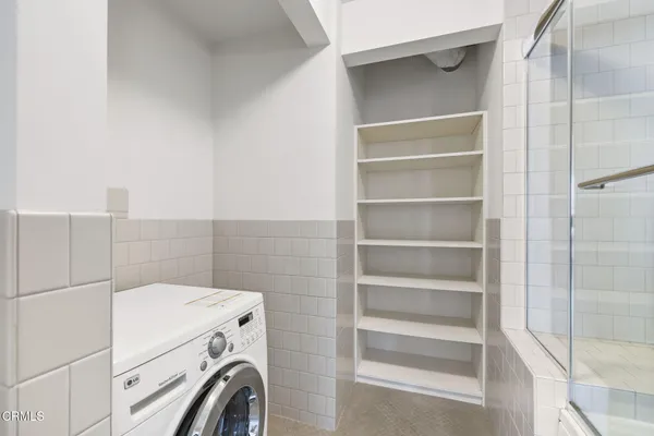 a view of storage and utility room with washer and dryer