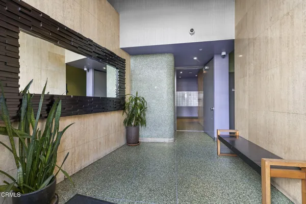 a view of entryway and hall with a potted plant