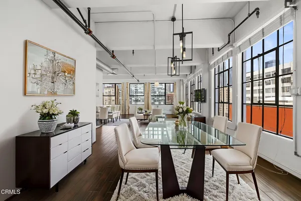 a view of a dining room with furniture window and wooden floor