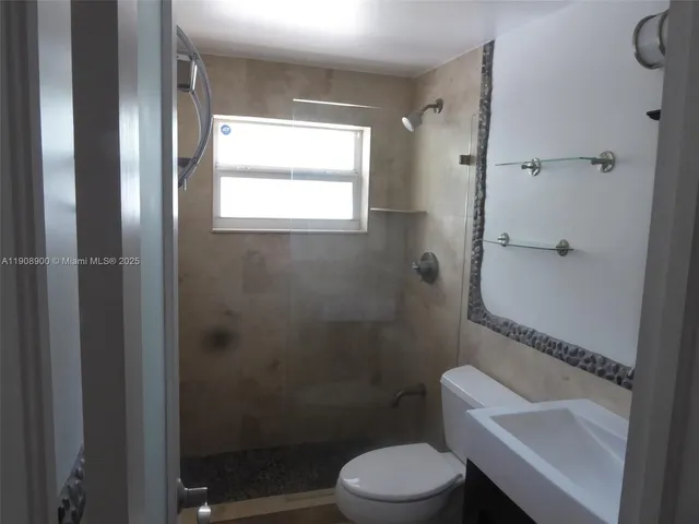 a bathroom with a toilet a sink and shower