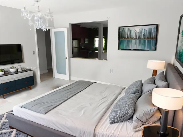 a bedroom with a bed and a television