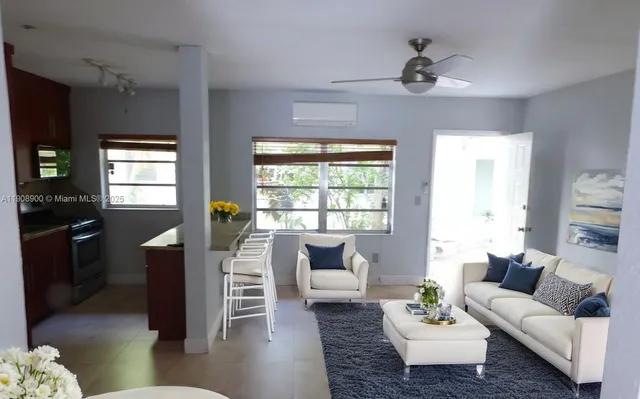 a living room with furniture and a large window