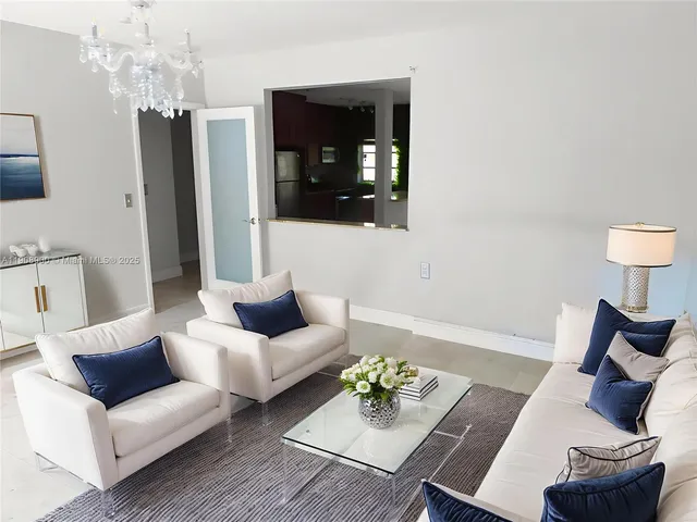 a living room with furniture and a lamp