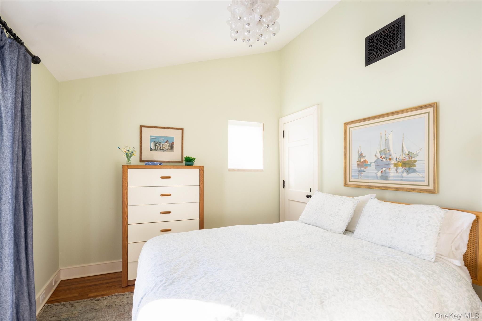 2840 Stars Road East Marion, NY 11939 - Photo 31 of 43 a bedroom with a bed and a painting on the wall