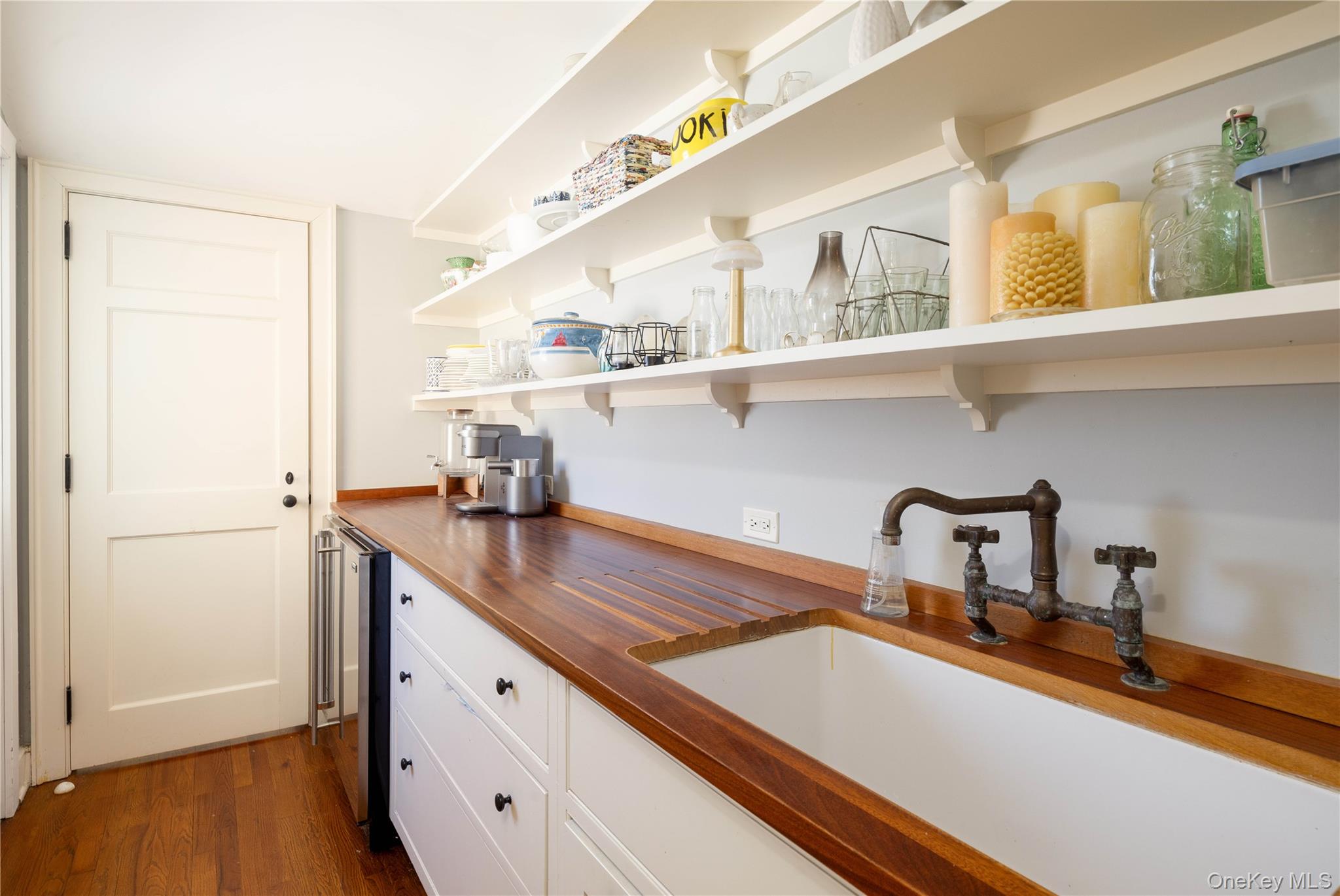 2840 Stars Road East Marion, NY 11939 - Photo 33 of 43 a kitchen with a sink and a refrigerator