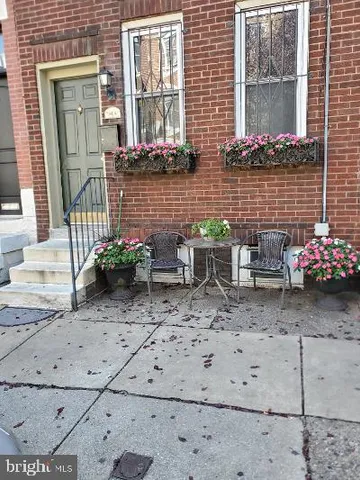 a view of a wooden bench with chairs
