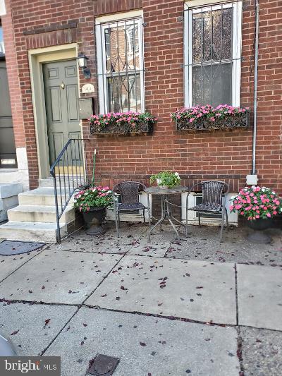 a view of a wooden bench with chairs