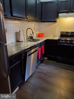 914 Ellsworth Street Philadelphia, PA 19147 - Photo 5 of 14 a kitchen with granite countertop a sink and cabinets