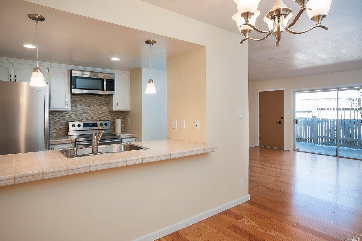 a kitchen with stainless steel appliances a refrigerator and microwave