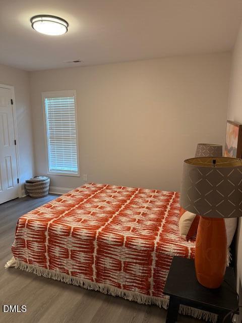 415 Sowell Street Durham, NC 27701 - Photo 13 of 17 a bedroom with a bed and dresser