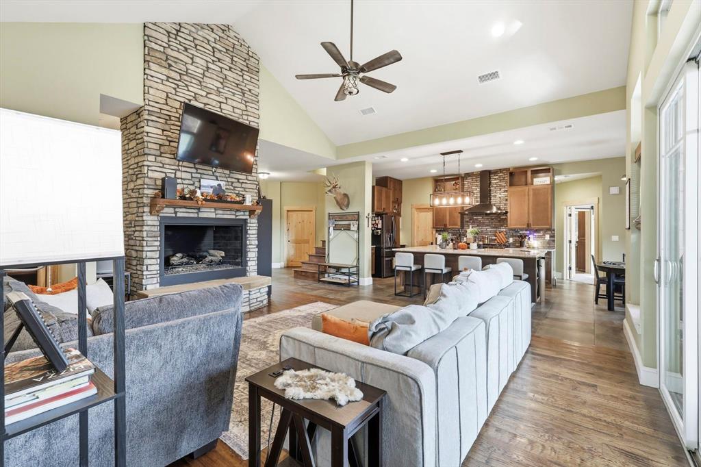 3300 Rigsby Lane Celina, TX 75009 - Photo 11 of 40 Living area featuring a fireplace, high vaulted ceiling, a ceiling fan, recessed lighting, and dark wood-style flooring