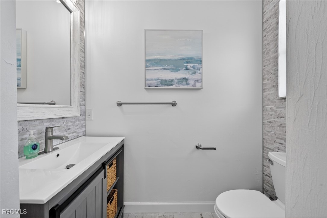 13570 Harbour Ridge Drive Fort Myers, FL 33908 - Photo 38 of 50 a bathroom with a toilet sink and mirror