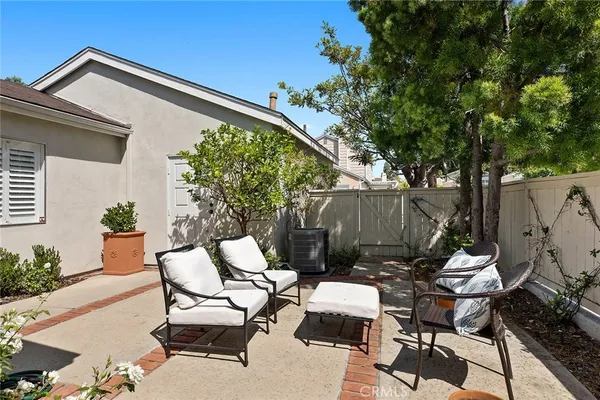 a view of backyard with outdoor seating and green space