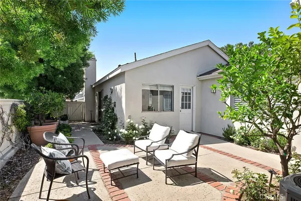 a view of backyard of house with seating space