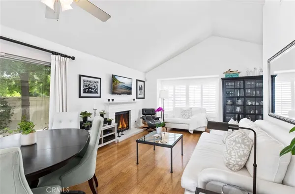 a living room with fireplace furniture and a large window