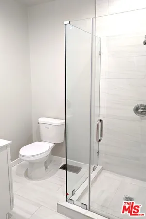 a bathroom with a toilet and a shower