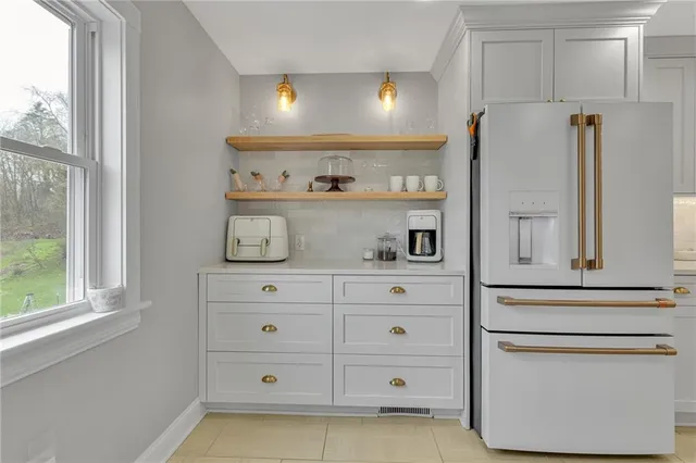 a open kitchen with stainless steel appliances granite countertop a refrigerator and a stove