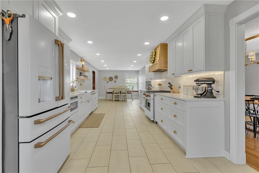 100 Roosevelt Drive Monaca, PA 15061 - Photo 9 of 39 a open kitchen with stainless steel appliances granite countertop a refrigerator and a stove