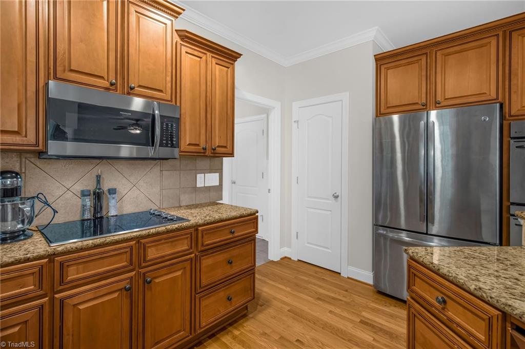 8916 Grove Park Drive Oak Ridge, NC 27310 - Photo 14 of 29 Stove and microwave