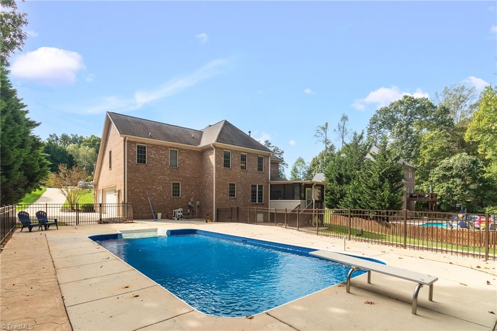 8916 Grove Park Drive Oak Ridge, NC 27310 - Photo 26 of 29 Rear view, pool and garage