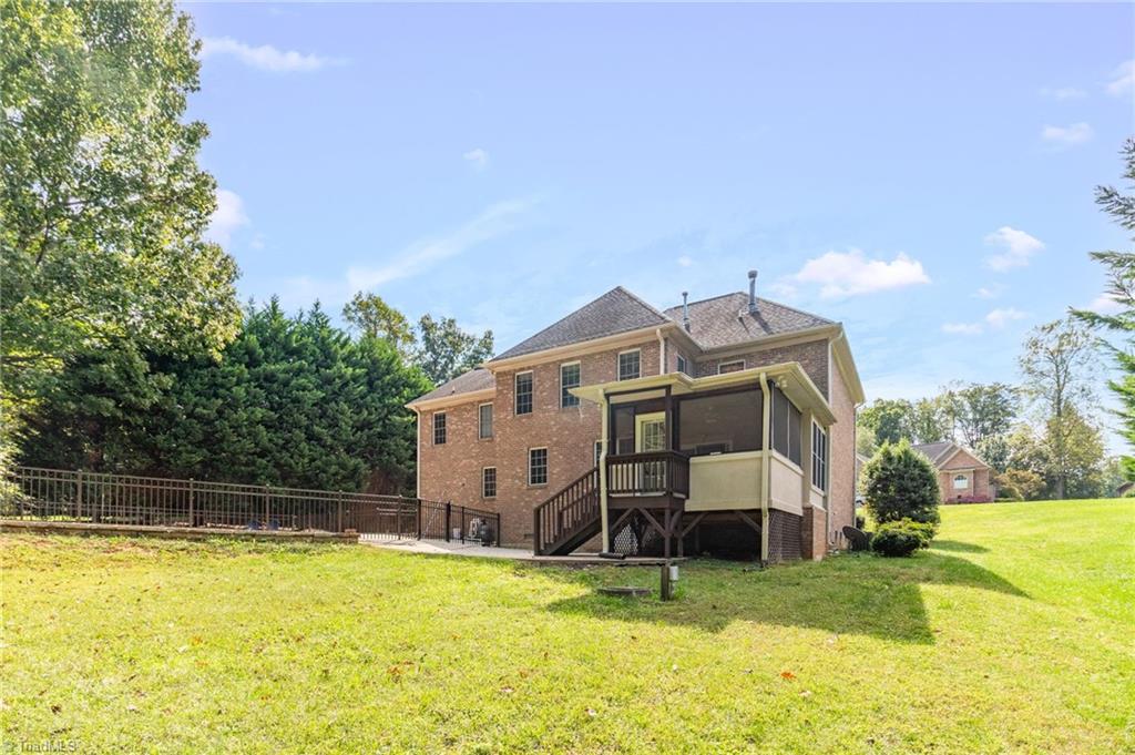 8916 Grove Park Drive Oak Ridge, NC 27310 - Photo 29 of 29 Backyard side view