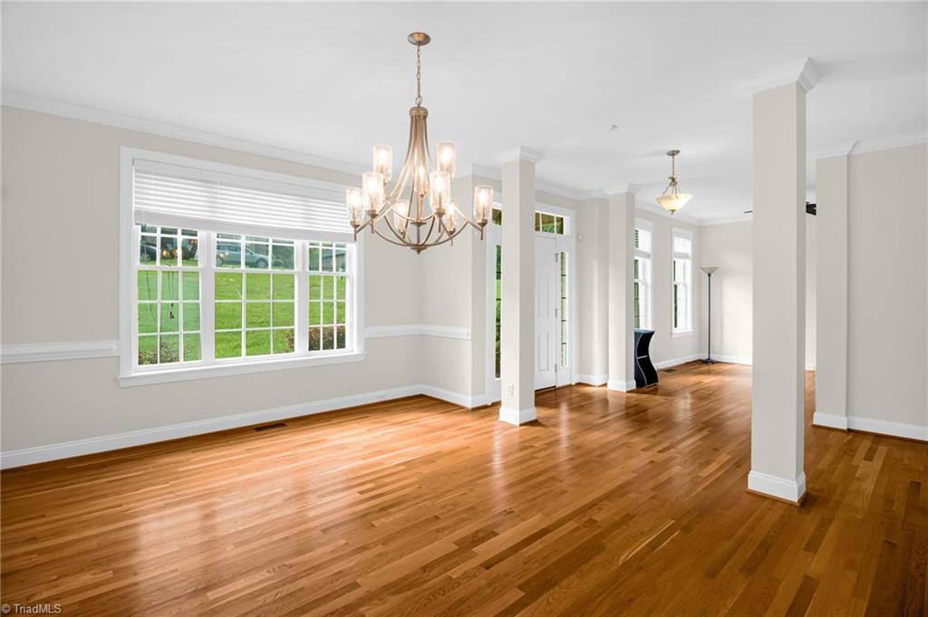 8916 Grove Park Drive Oak Ridge, NC 27310 - Photo 3 of 29 Sunlit formal dining room and front door entry